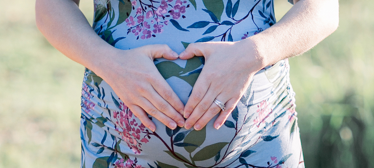 Hands over pregnant belly